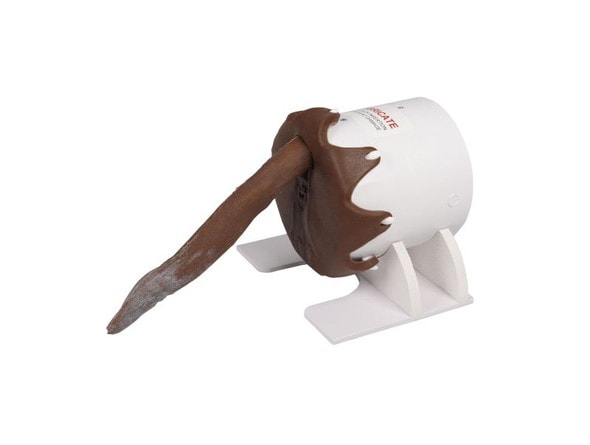 A canine rectal exam task trainer featuring a realistic brown silicone perineum and tail mounted on a white modular base.